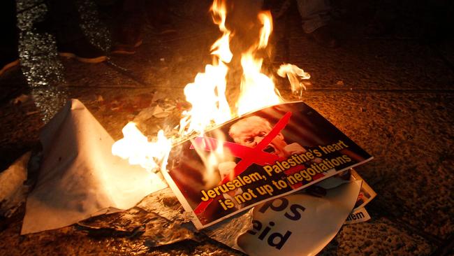 Palestinian demonstrators burn posters of President Trump following his declaration of Jerusalem as Israel's capital. (Pic: Musa Al Shaer)