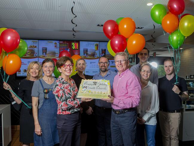 Michael Power, who owns five McDonald's restaurants on the northern Gold Coast, at the Siganto Drive, Helensvale outlet, with his wife Deanna Power and staff, including Wendy Booker, celebrating 30 years in business. Picture: Jerad Williams.