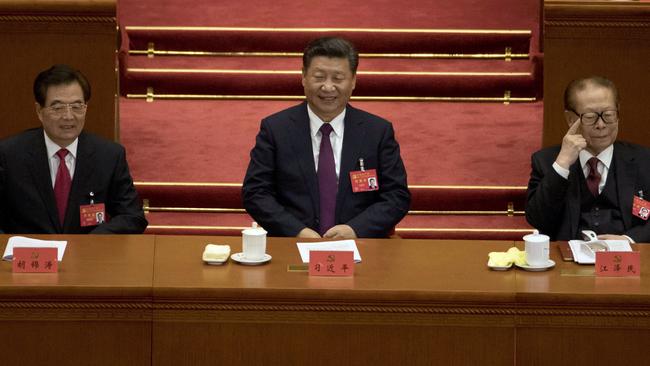 Chinese President Xi Jinping (centre) sits with former Chinese President Hu Jintao (left) and Jiang Zemin. Picture: Ng Han Guan/AP