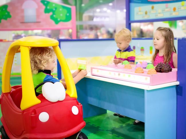 Child playing in toy shop or restaurant. Educational toys and role game for kids. Kindergarten or preschool play room. Toddler kid at day care playground. Grocery store or supermarket for children.