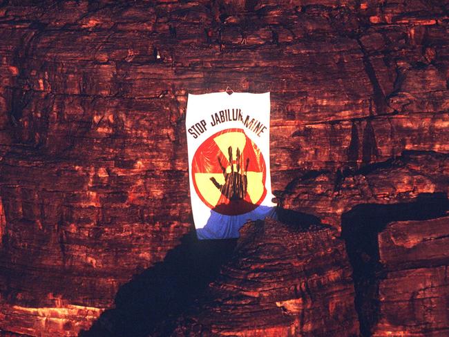 Ten Mirarr Traditional Owners dropped a giant 'Stop Jabiluka Mine' banner from a cliff face overlooking Oenpelli Rd in June 1997. Picture: Supplied