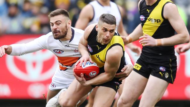 Presti breaks a Stephen Coniglio tackle against the Giants this month. Picture: Getty Images