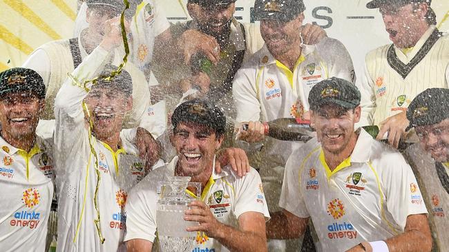 Australia's captain Pat Cummins celebrates with the Ashes trophy. Photo by William WEST / AFP.