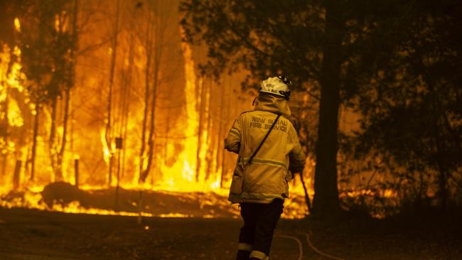 RFS Firefighters desperately worked to save a home at Bawley Point. Picture: Gary Ramage