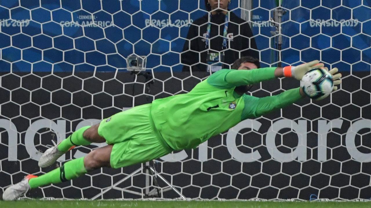 Brazil's goalkeeper Alisson stops the shot by Paraguay's Gustavo Gomez in the penalty shoot-out.