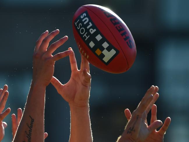 An assortment of hands reach for a Sherrin AFL football  during their round 16 match between the Greater Western Sydney Giants and the Adelaide Crows at Spotless Stadium, Sydney, Saturday, July 5, 2014. (AAP Image/Dean Lewins) NO ARCHIVING, EDITORIAL USE ONLY