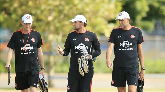 Coach, Tony Popovic, c, arrives for training with assistants Hayden Foxe and Zeljko Kalac.