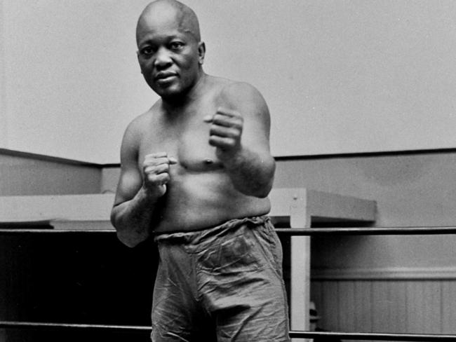 In this 1932 file photo, boxer Jack Johnson, the first black world heavyweight champion, poses in New York City. Donald Trump gave him a rare pardon in May. Picture: AP