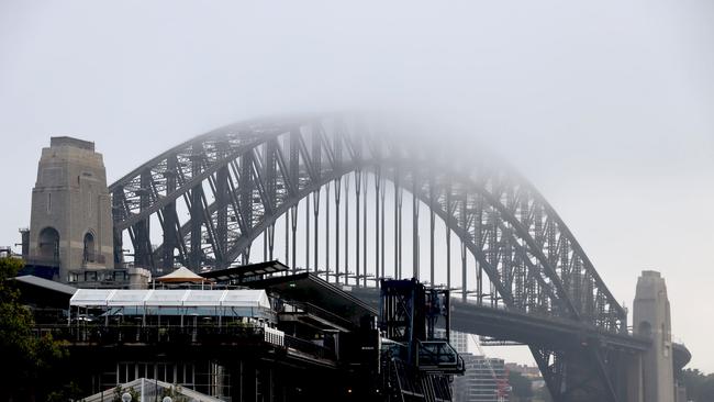 The Sydney Harbour Bridge is pictured as blanket of fog rolls over Sydney on Wednesday morning, ahead of a big snow dump due to hit the Alpine regions later this week. Picture: NCA NewsWire / Nicholas Eagar