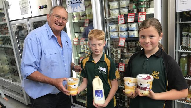 John Cochrane (left) from Kenilworth Dairies has donated yoghurt and milk to the local school. The students pictured are Connor Nicholls and Abby Gibbs.