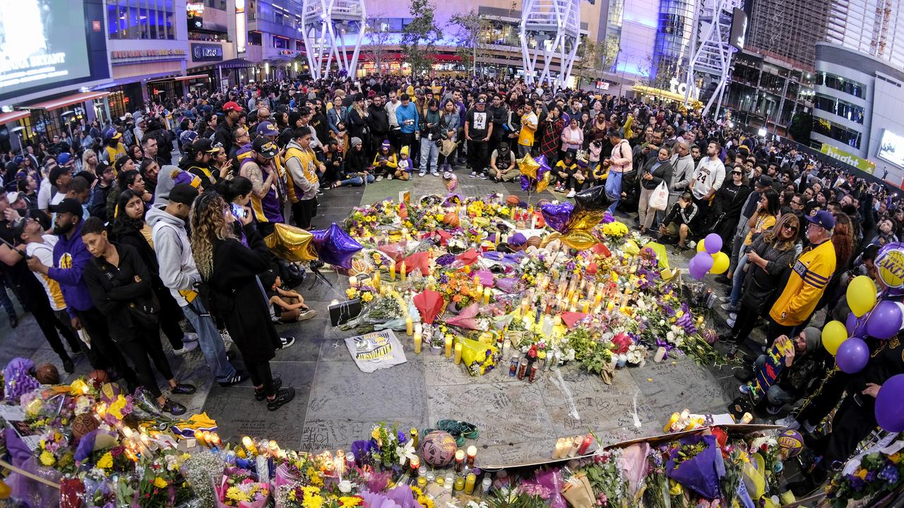 People gather at a memorial for Kobe Bryant near the Staples Centre. Picture: AP Photo/Ringo H.W. Chiu