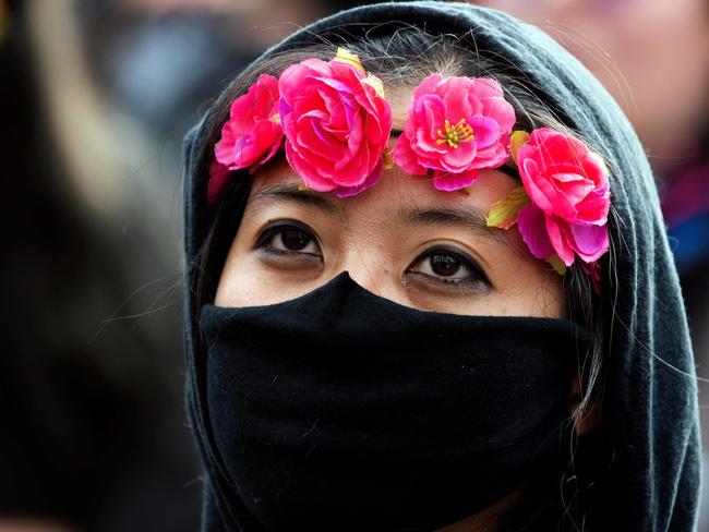 A demonstrator wears a ring of roses along with a face mask during a protest in Denver, Colorado. Picture: AFP