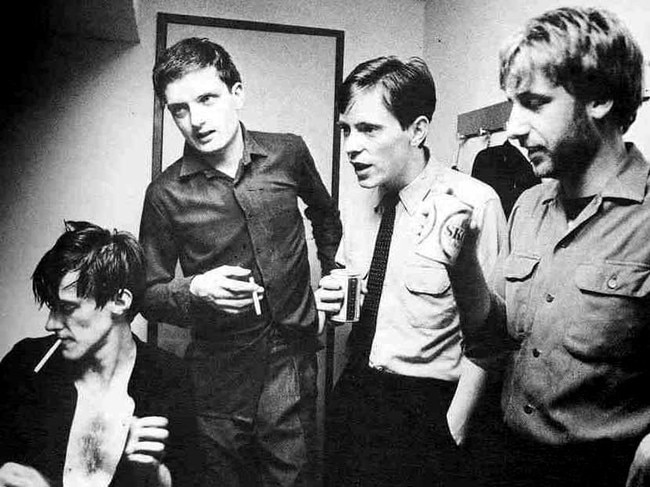 Ian Curtis (second from left) with Joy Division. Band. Music group.