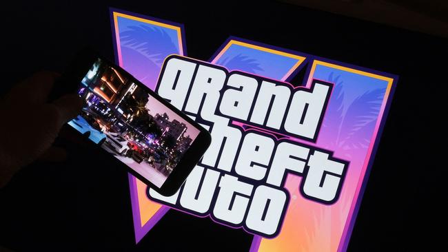 (FILES) This illustration photo created in Los Angeles, December 4, 2023, shows Rockstar Gamesâ Grand Theft Auto VI trailer played on a screen in front of the game title. The much-awaited release of Grand Theft Auto VI, the latest installment of the popular video game series, has been postponed by several months to May 2026, its publisher said on May 2, 2025. (Photo by Chris DELMAS / AFP)