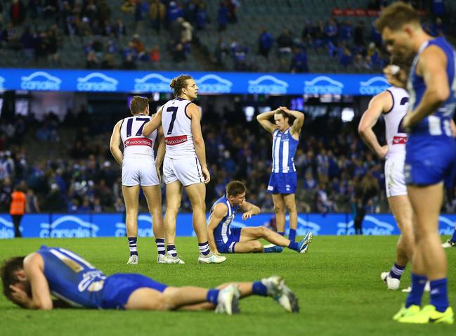 MELBOURNE, AUSTRALIA - JULY 09:  Nat Fyfe of the Dockers celebrates at the final siren as Kangaroos players look dejected during the round 16 AFL match between the North Melbourne Kangaroos and the Fremantle Dockers at Etihad Stadium on July 9, 2017 in Melbourne, Australia.  (Photo by Scott Barbour/Getty Images)