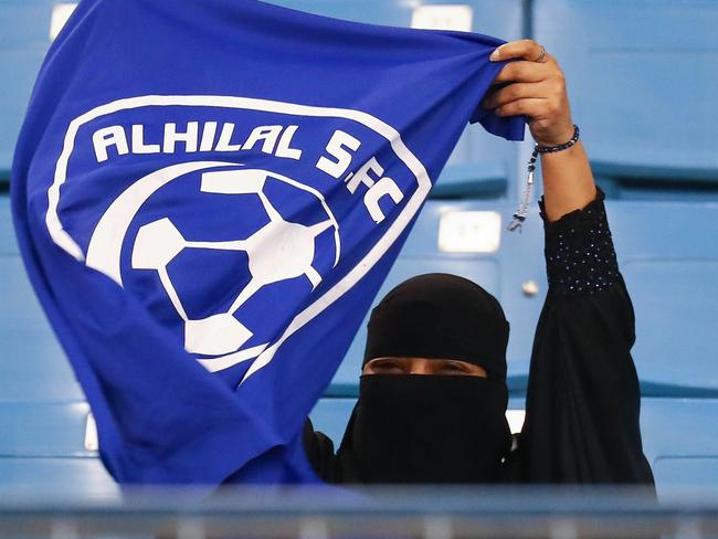 A female supporter of Saudi's Al-Hilal attends her team's football match against Al-Ittihad in the Saudi Pro League at the King Fahd International Stadium in Riyadh on January 13, 2018. Saudi Arabia allowed women to enter a football stadium for the first time to watch a match on January 12, as the ultra-conservative kingdom eases strict decades-old rules separating the sexes. / AFP PHOTO / Ali AL-ARIFI