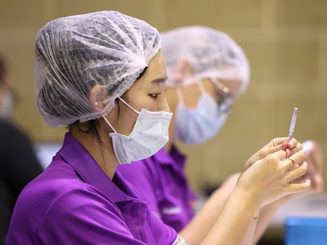 Clinical staff handle AstraZeneca Covid-19 vaccine syringes at the Claremont Showgrounds in Perth. Picture: Getty Images