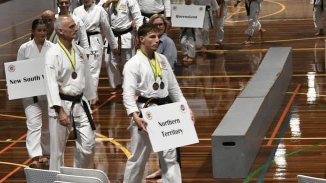 Alice Springs local Harrison Bowhay (centre) has represented the Territory in karate competition. Picture: Supplied