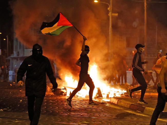 Palestinian protesters hurl stones during clashes with Israeli forces in the Shuafat Palestinian neighbourhood, neighbouring the Israeli settlement of Ramat Shlomo, in Israeli-annexed east Jerusalem. Picture: AFP