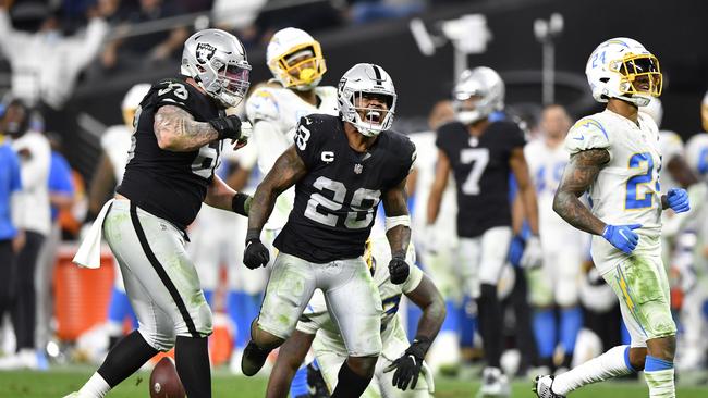 LAS VEGAS, NEVADA - JANUARY 09: Josh Jacobs #28 of the Las Vegas Raiders celebrates during overtime against the Los Angeles Chargers at Allegiant Stadium on January 09, 2022 in Las Vegas, Nevada. (Photo by Chris Unger/Getty Images)