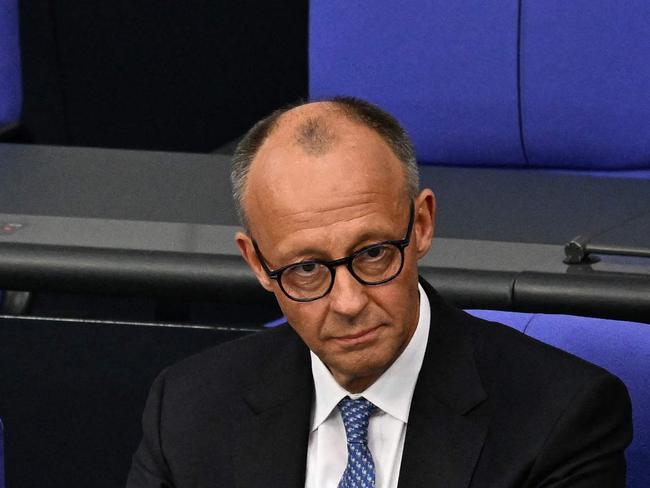Newly elected German Chancellor Friedrich Merz sits alone on the Chancellor's seat after taking the oath during a swearing in session after a second round of voting at the Bundestag (lower house of parliament) in Berlin on May 6, 2025. German lawmakers on May 6, 2025 elected conservative Friedrich Merz as chancellor in a second-round vote, a victory marred by his surprise defeat in an initial ballot. Merz, 69, scored an absolute majority of 325 against 289 in the secret vote in the lower house of parliament. (Photo by RALF HIRSCHBERGER / AFP)
