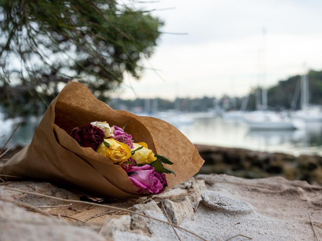 Flowers laid in honour of Cecilia Haddad at the Lane Cove River shoreline where she was found murdered.