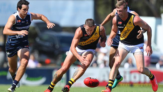 Recruit Jesse White attempts to pick up the loose ball in his first game for Glenelg after crossing from Collingwood. Picture: TAIT SCHMAAL