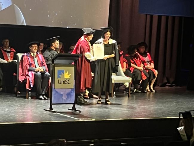 Graduates from the University of the Sunshine Coast's Fraser Coast campus celebrating at the Brolga Theatre.