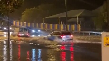 Cars on Guildford Rd in Perth's northeast tried to traverse flooded roads on Sunday night.