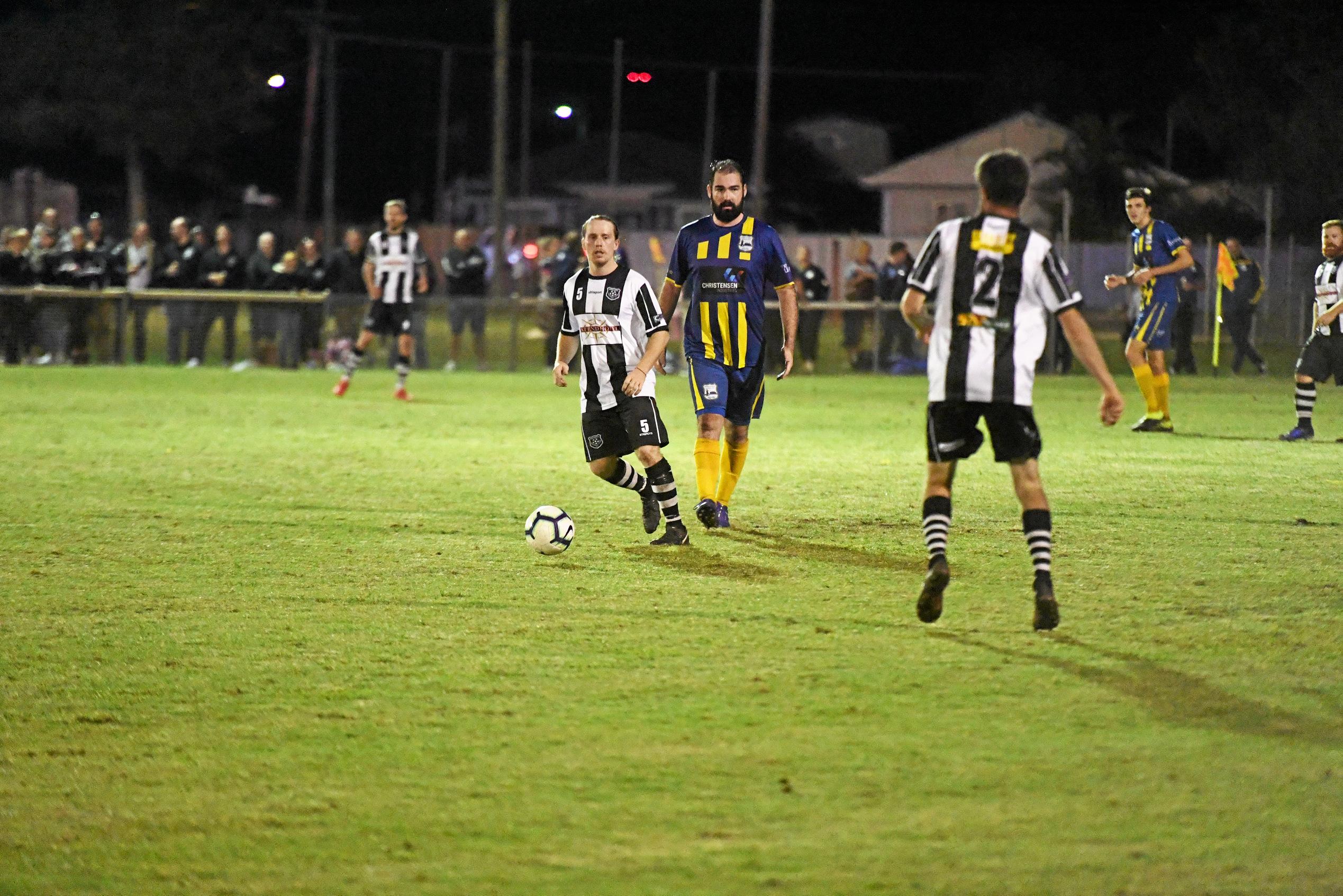 Bingera's Josh Medcalf tries to keep the ball away from The Waves Sam Meyer. Picture: Shane Jones