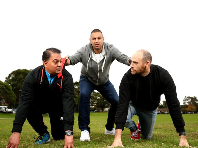 Comedian Rob Shehadie (pictured centre) tries to keep dads Cyrus Boomla and Andy Jones in order at Doyles ground in North Parramatta ahead of the Dads v Dads soccer match.