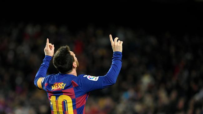 (FILES) In this file photo taken on January 19, 2020 Barcelona's Argentine forward Lionel Messi celebrates scoring the opening goal during the Spanish league football match between FC Barcelona and Granada FC at the Camp Nou stadium in Barcelona. – Plan A was to stay at Barcelona but after the Catalan club, home for his entire career, ruefully accepted it cannot afford him any more, Lionel Messi was expected to be about to embark on plan P for Paris on August 7, 2021. French fans and media alike were salivating on the effect the superstar's mooted arrival at Paris Saint-Germain would have on the club and the French league as a whole amid reports the Argentinian will end up in the capital. (Photo by LLUIS GENE / AFP)