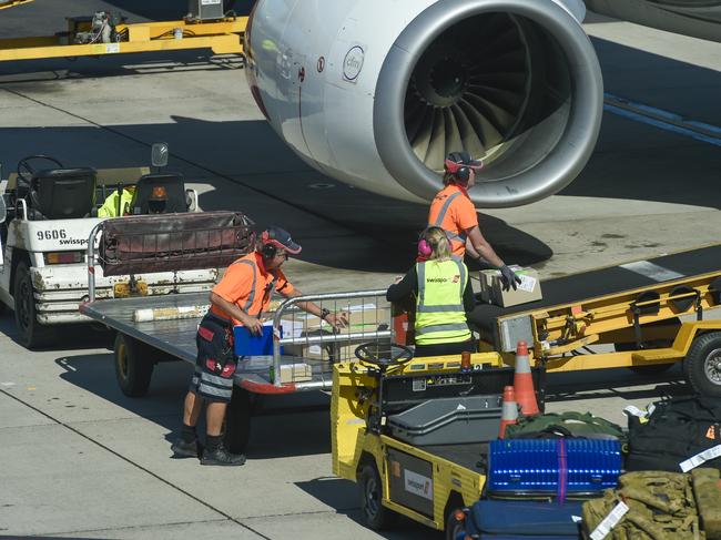 Qantas airport baggage handlers wearing protective gear while the supervisor (Not Sure) but looks as if he was giving orders was not wearing any protective gear at all and was not practising safe distance rules.Thursday April 2 2020.PIC SUPPLIED