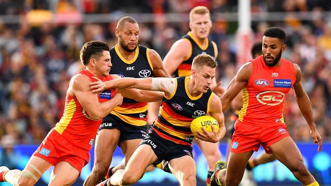 David Mackay fends off against the Gold Coast. Picture: Daniel Kalisz/Getty Images