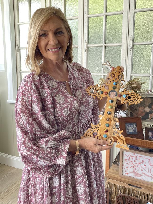 Jo Dodt proudly displays an artwork her father made for her, with each marble representing a round of chemotherapy.