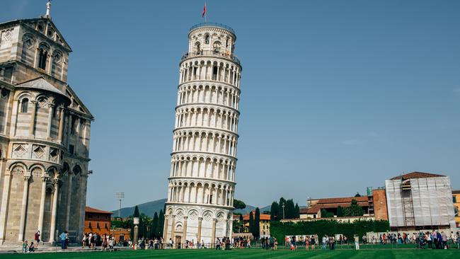 Pisa, Italy - October 6, 2015: Tourists are strolling along Cathedral and Leaning Tower of Pisa on Square of Miraclesis (Piazza dei Miracoli), Italy.