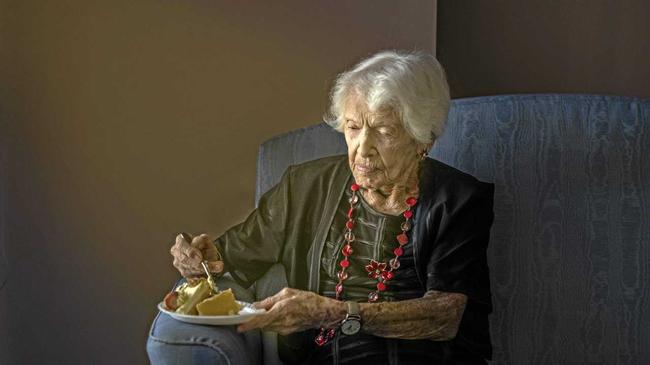 Winifred Jefferies, spends a quiet moment with a piece of cake as she prepares to celebrate her 107th birthday. Picture: Adam Hourigan