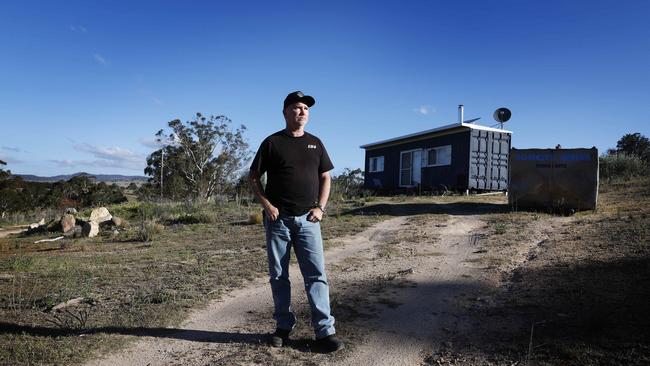 Fitzgerald and the shipping container he calls home. Picture: John Feder