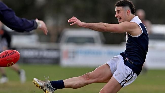 Melton South’s Mitch Fino gets a kick. Picture: Andy Brownbill