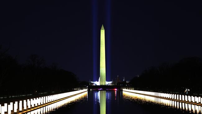 Columns representing victims of coronavirus are lit up along the sides of the Lincoln Memorial Reflecting Pool after President-elect Joe Biden and Vice President-elect Kamala Harris attended a memorial on the eve of the presidential inauguration. Picture: Michael M. Santiago/Getty Images/AFP