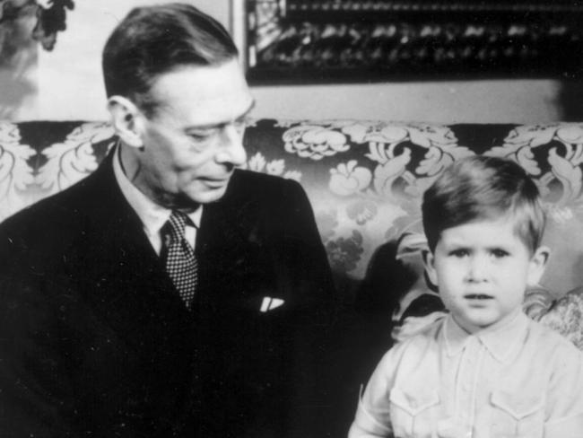 Queen Mother holds Princess Anne, while husband King George VI (Sixth) watches Prince Charles (later Prince of Wales) on occasion of Charles' third birthday, 14/11/51. Pic Central Press                Royals / Family