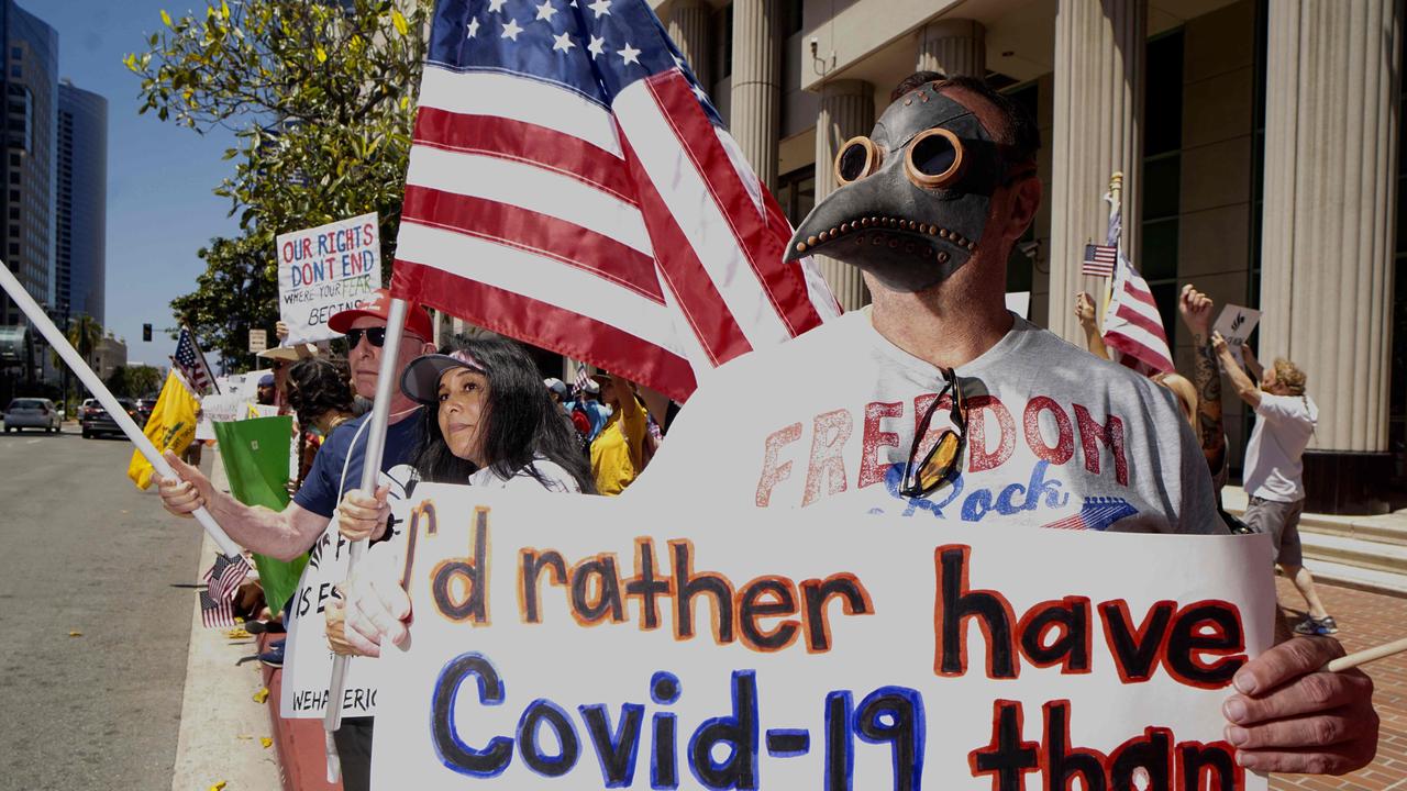 A demonstrator wearing a plague doctor mask protests in San Diego. Picture: Sandy Huffaker/AFP