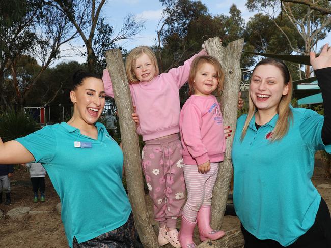 Educators Isabella Defrancesco and Kayla Macleod with Ruby and Willow. One World for Children, a North Geelong childcare centre, has won Victorian small employer of the year training award. Picture: Alan Barber