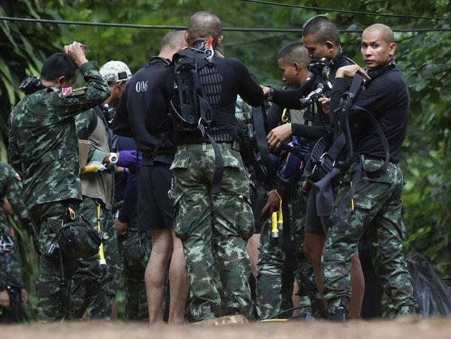 Divers at the scene where 12 boys and their soccer coach were trapped inside a Thai cave complex last July. Picture: AP