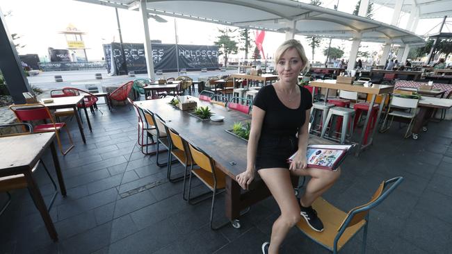 Mercedes Frenger, 31, assistant manager of Gringo Loco Cantina... with her empty restaurant and bar, which is in the prime position on the beach at the end of Cavill Avenue. Mercedes says the Games killed Easter for them. Picture: Lyndon Mechielsen/The Australian