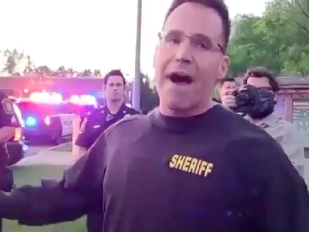 Sheriff Chris Swanson took off his helmet and baton and joined the protest.