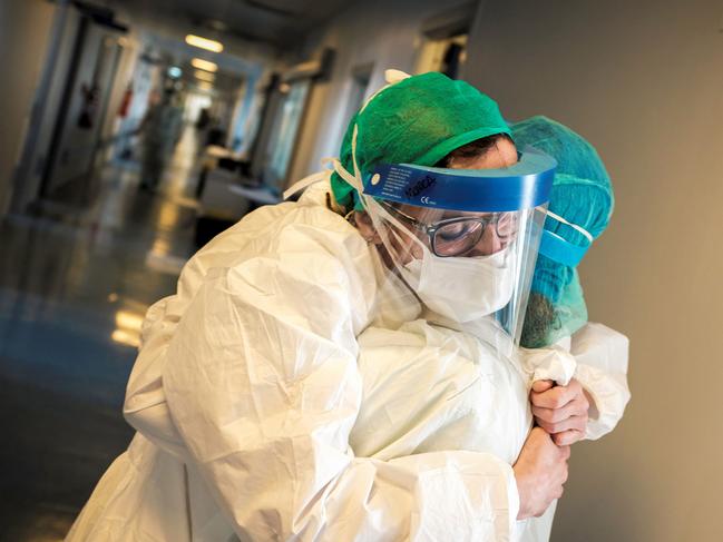 Nurses wearing protective mask and gear embrace at the Cremona hospital, southeast of Milan, Lombardy, during the country's lockdown. Picture: AFP