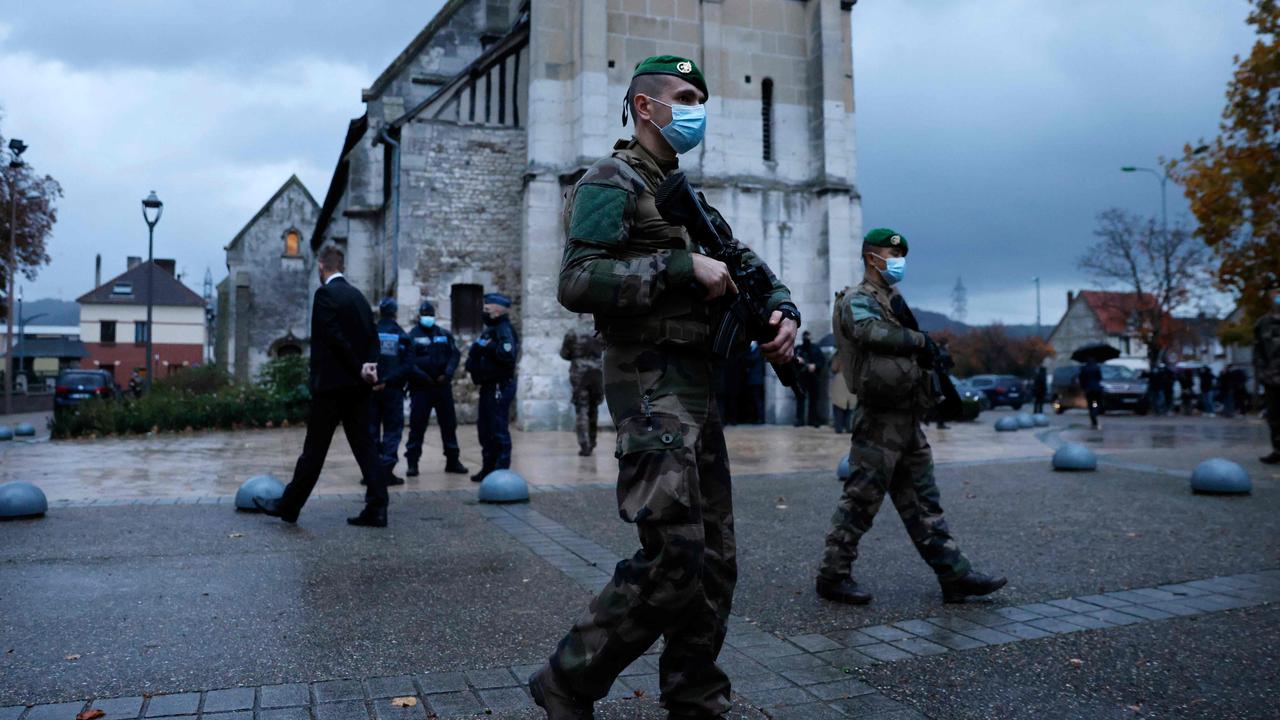 French soldiers of the Sentinelle force patrol in front of the church of Saint-Etienne du Rouvray two days after a knife attacker killed three people at the Basilica of Notre-Dame de Nice. Picture: THOMAS COEX / POOL / AFP.