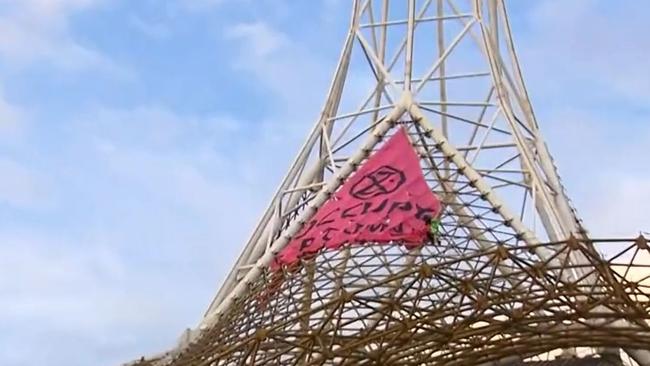 A man has climbed a spire to protest delayed climate action. Picture: Sunrise​