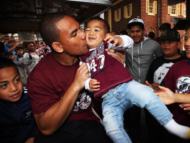 NRL - The Manly Sea Eagles parade through the streets of Manly after last weekend's Grand Final win over the Warriors. Will Hopoate gives his baby brother Devida a kiss.